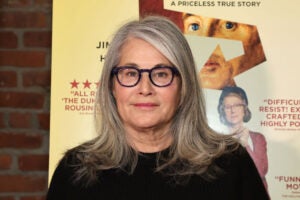 Lorraine Bracco attends a screening of "The Duke" wearing thick black framed glasses with grey hair parted to the right.